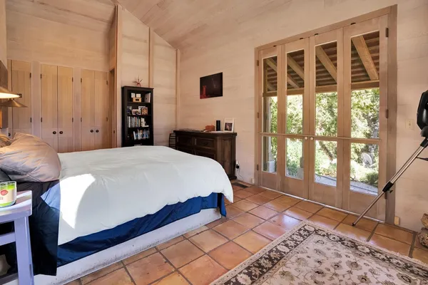 a bed sitting in a bedroom next to a window