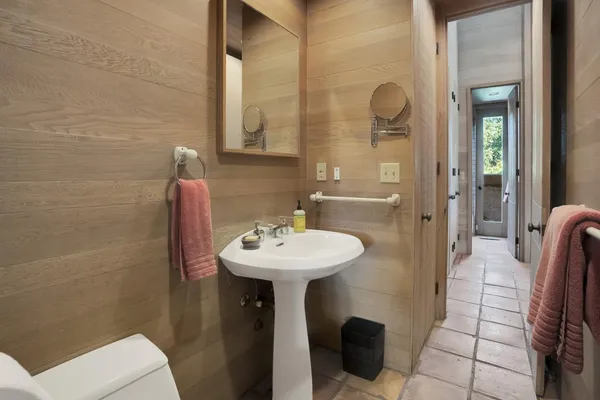 a bathroom with a sink a toilet and shower