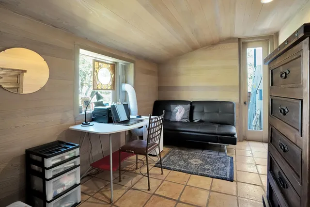 a living room with furniture a dining table and a fireplace