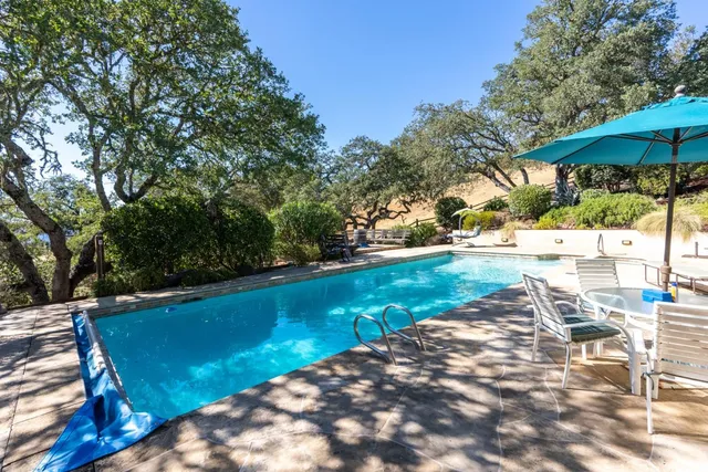 a view of a swimming pool with a patio