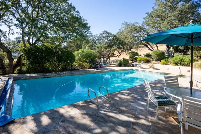 a view of a swimming pool with a patio
