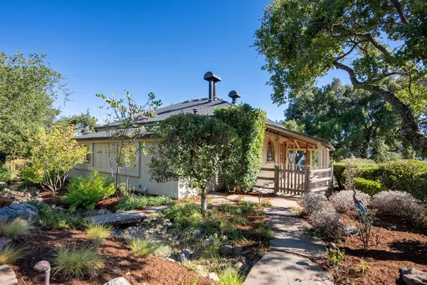 a front view of a house with garden