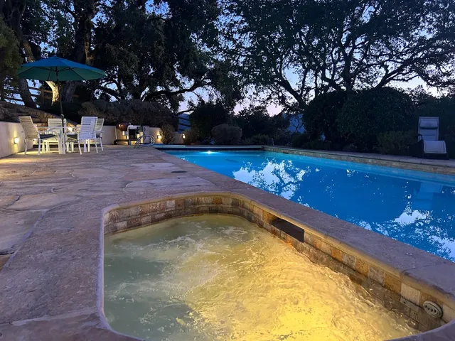 a view of swimming pool with an outdoor seating
