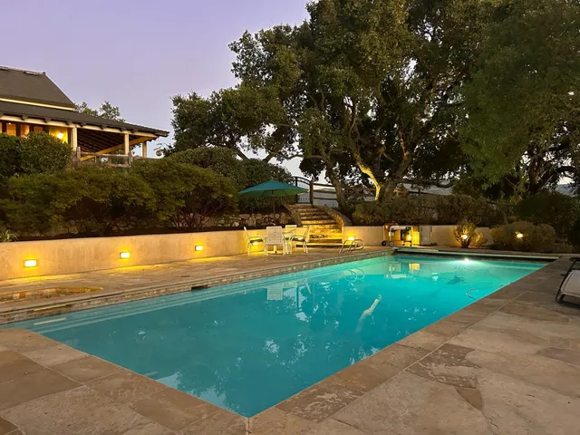 a view of a swimming pool with an outdoor space and seating area