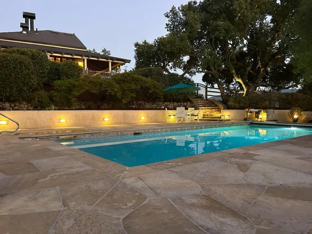 a view of a house with a yard and lake view