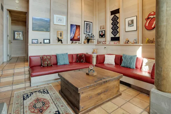 a living room with furniture and painting on the wall