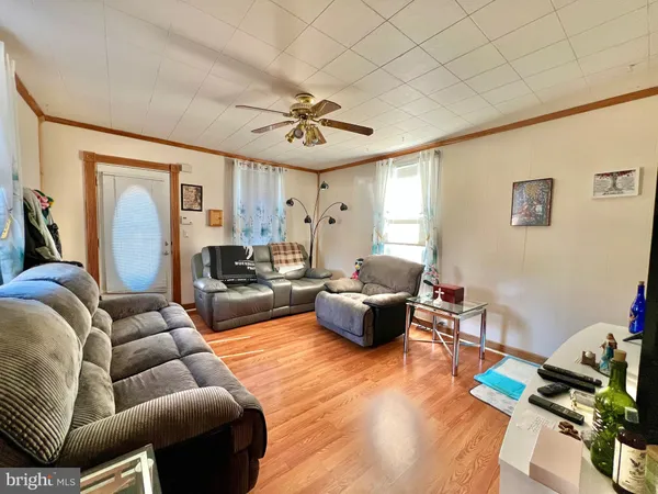 a living room with furniture or couch and a wooden floor