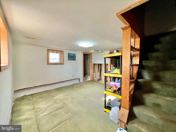 a living room with furniture and a book shelf