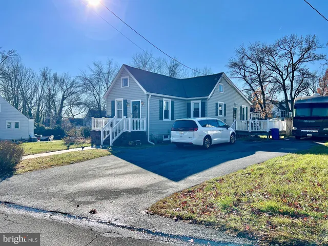 a front view of a house with cars parked
