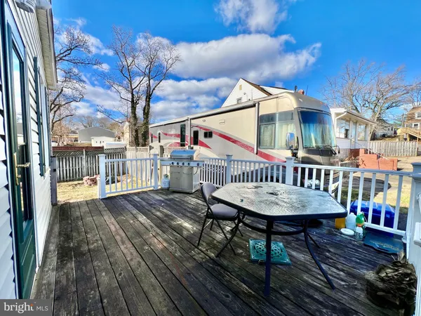 a view of a house with wooden deck and furniture