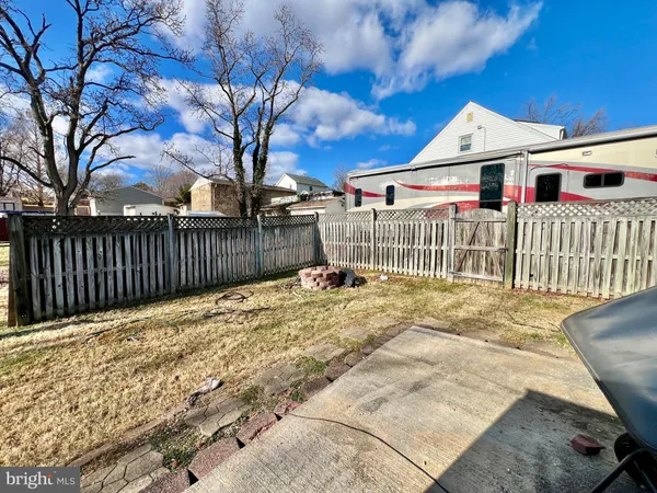 a view of a white house with wooden fence