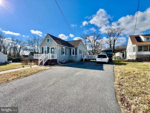 a view of a house with a yard covered in snow