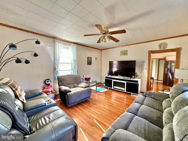 a living room with furniture and a flat screen tv