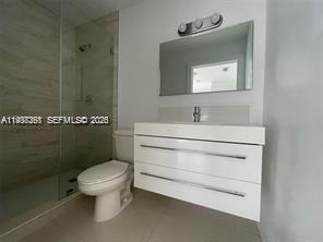 6441 Southwest 30th Street Miami, FL 33155 - Photo 12 of 13 a bathroom with a toilet sink and mirror
