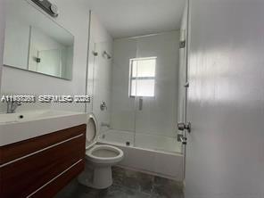 6441 Southwest 30th Street Miami, FL 33155 - Photo 13 of 13 a bathroom with a granite countertop toilet a sink and bathtub
