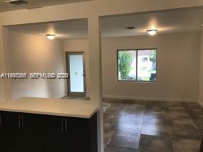 6441 Southwest 30th Street Miami, FL 33155 - Photo 6 of 13 a view of a hallway to a room with windows