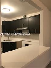 6441 Southwest 30th Street Miami, FL 33155 - Photo 7 of 13 a view of kitchen with kitchen island sink and stove