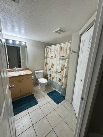a bathroom with a sink mirror vanity and toilet