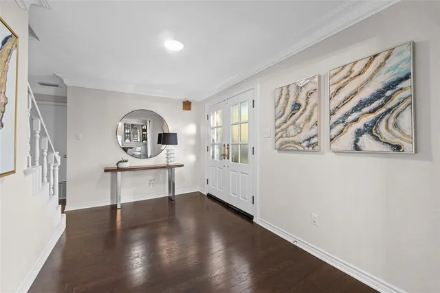 a view of a room with wooden floor and a window