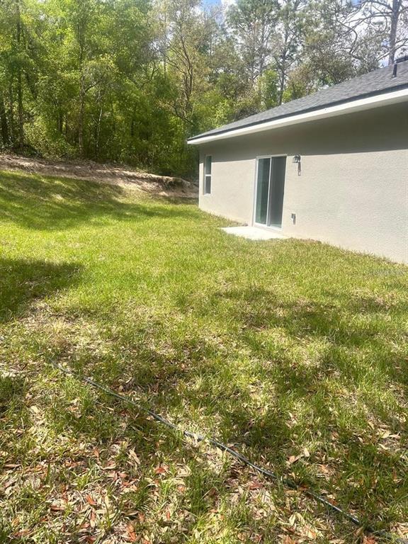 9451 North Emellia Avenue Citrus Springs, FL 34433 - Photo 23 of 24 a view of a house with a yard