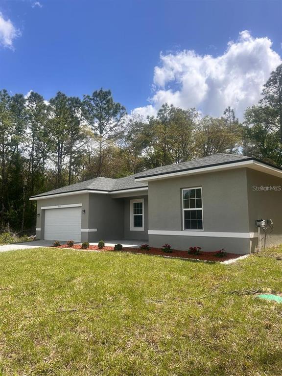 9451 North Emellia Avenue Citrus Springs, FL 34433 - Photo 6 of 24 a house view with a garden space