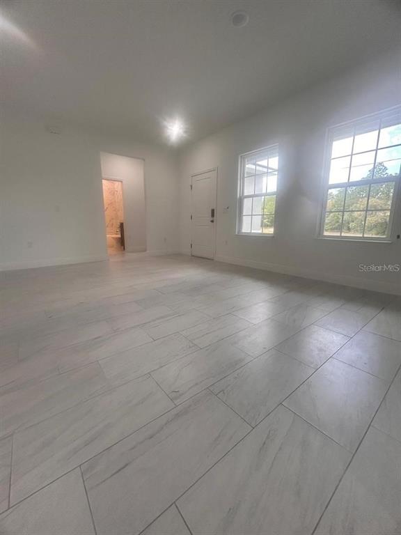 9451 North Emellia Avenue Citrus Springs, FL 34433 - Photo 7 of 24 an empty room with windows and fireplace