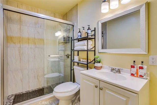 a bathroom with a sink a toilet and shower curtain