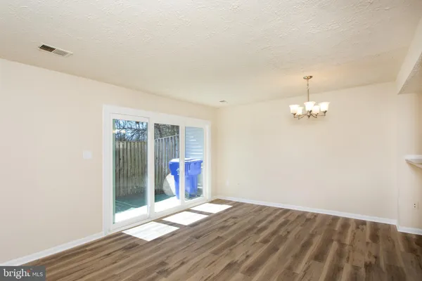 a view of an entryway with wooden floor