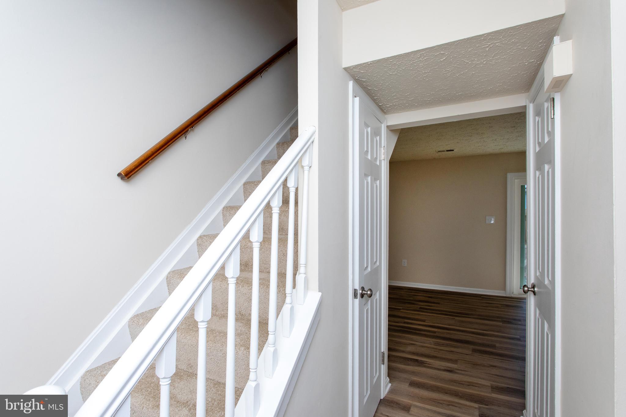 3147 Heath Cote Road Waldorf, MD 20602 - Photo 14 of 33 a view of a hallway with wooden floor and staircase
