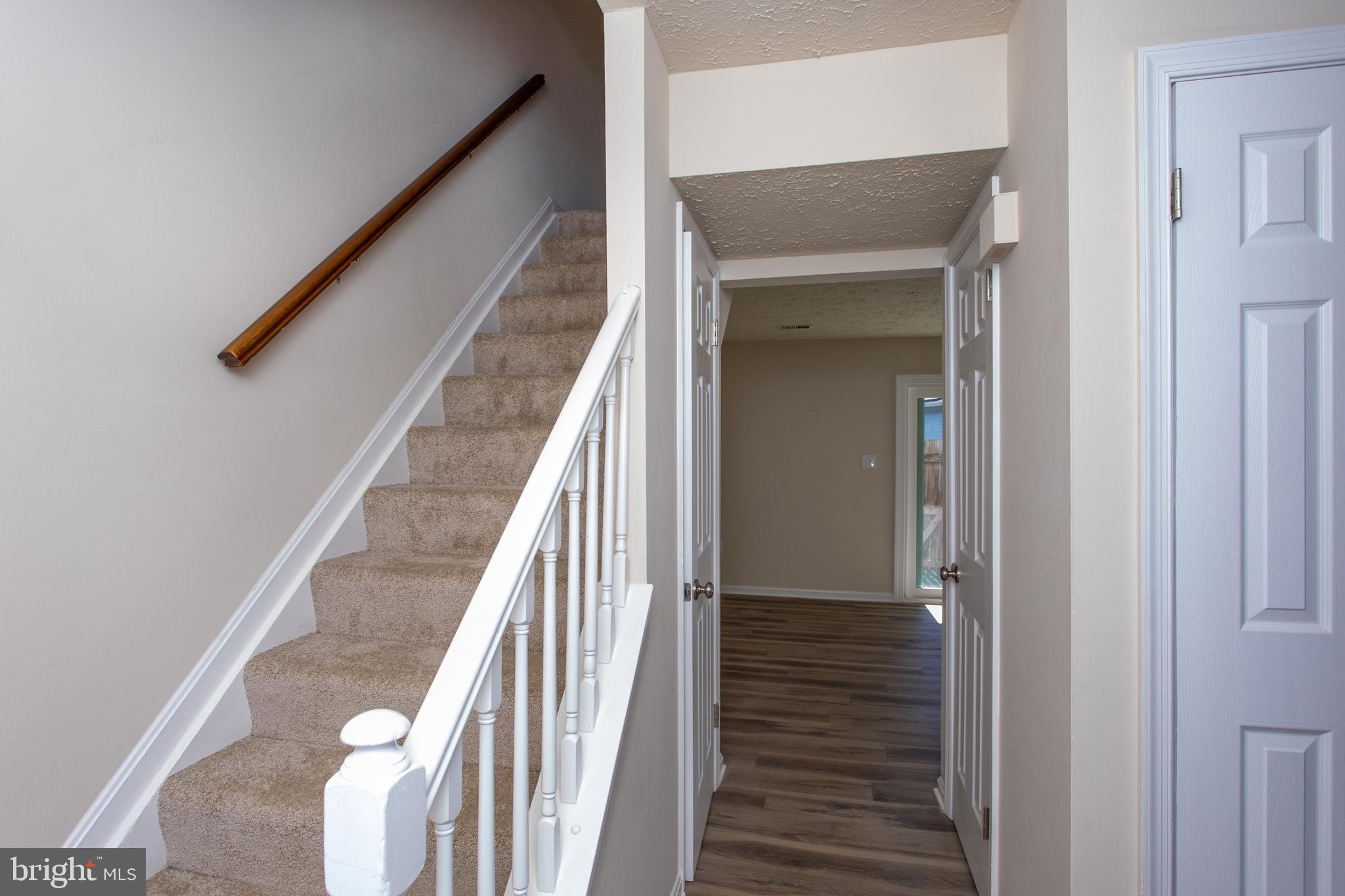 3147 Heath Cote Road Waldorf, MD 20602 - Photo 15 of 33 a view of a hallway with wooden floor and staircase