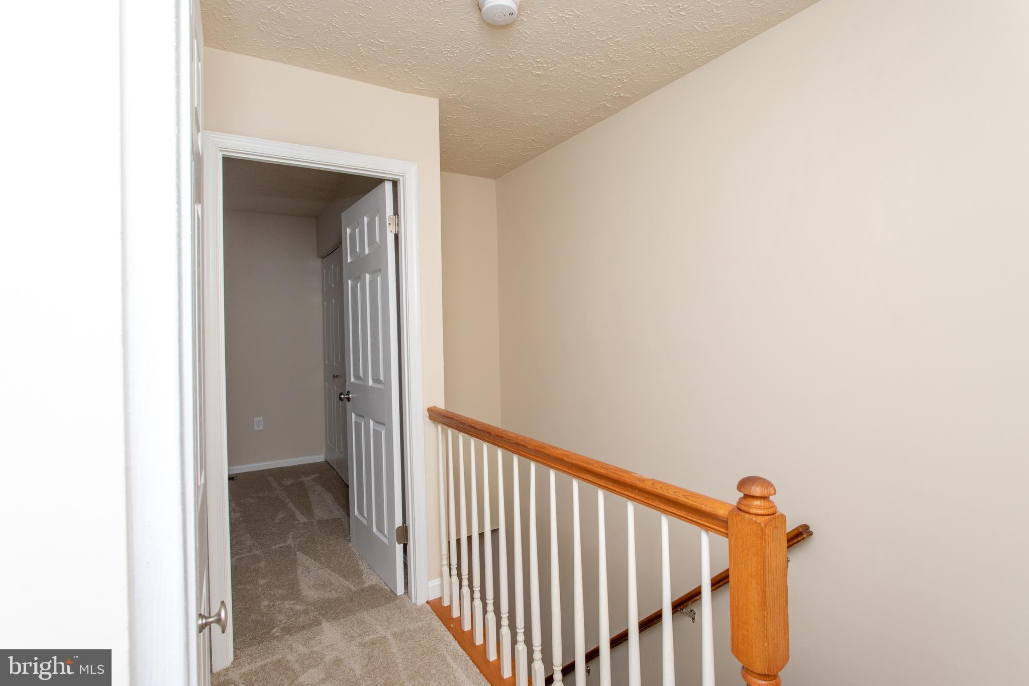 3147 Heath Cote Road Waldorf, MD 20602 - Photo 16 of 33 a view of a hallway with wooden floor