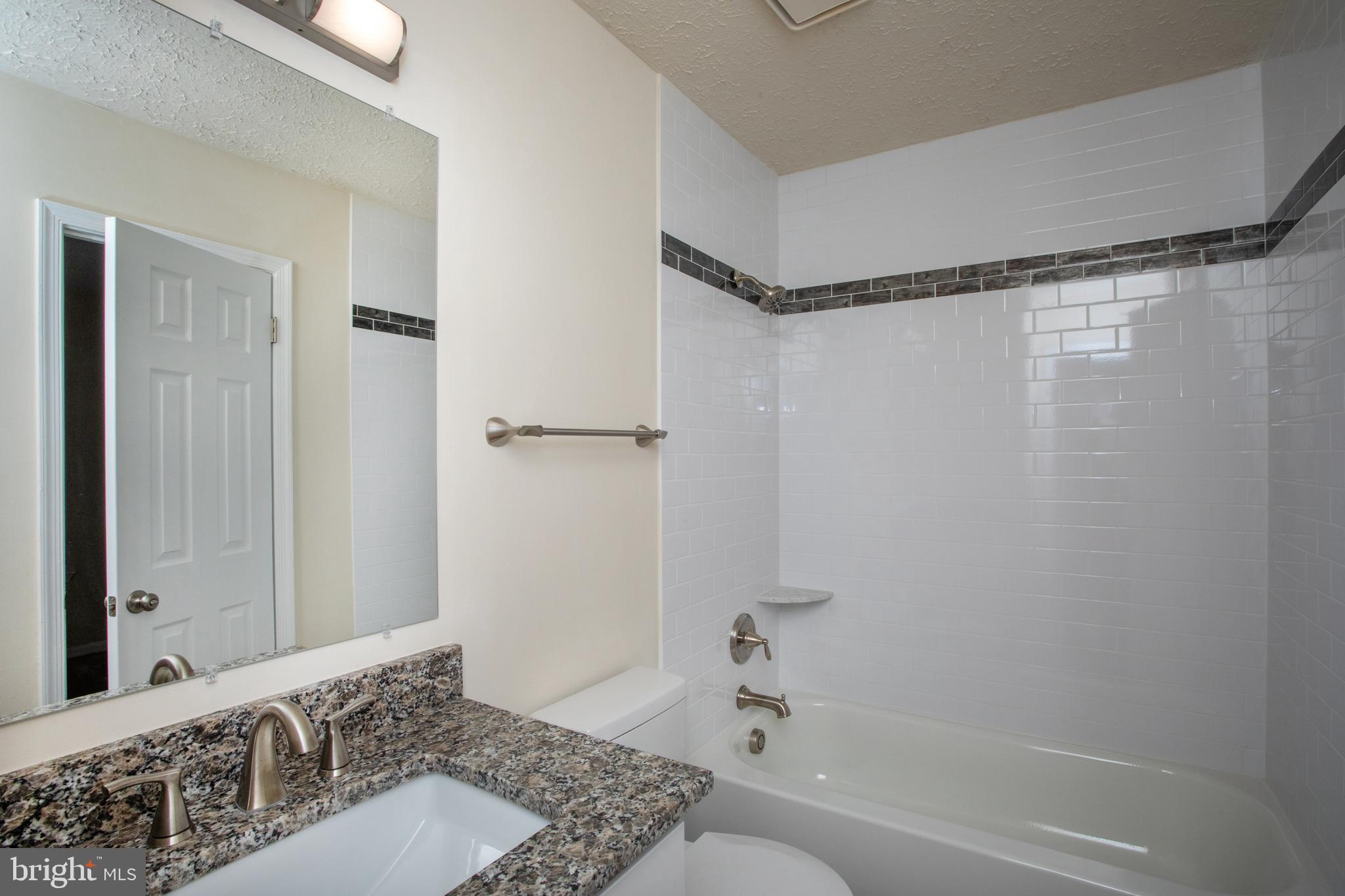 3147 Heath Cote Road Waldorf, MD 20602 - Photo 24 of 33 a bathroom with a tub shower sink and vanity