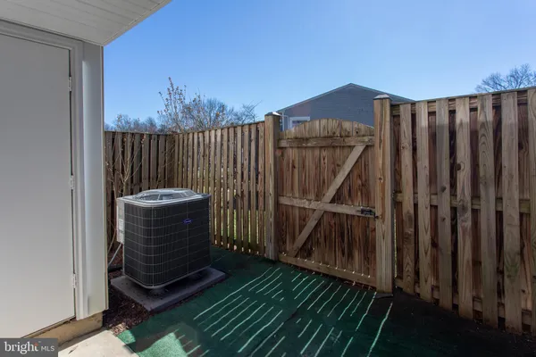 a view of a backyard with wooden fence