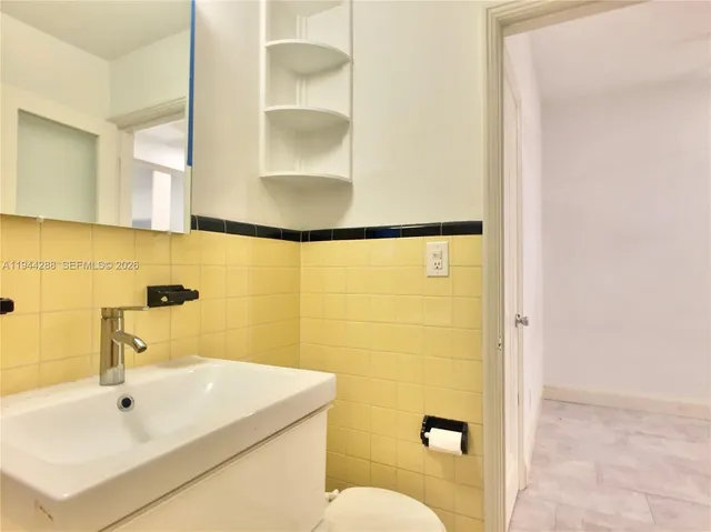 a bathroom with a sink and a blue shower