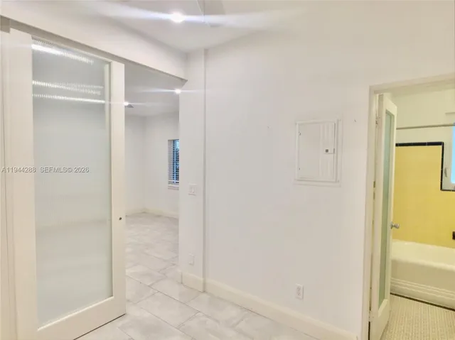 a bathroom with a glass shower door