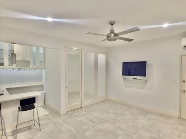 a view of an empty room with a ceiling fan
