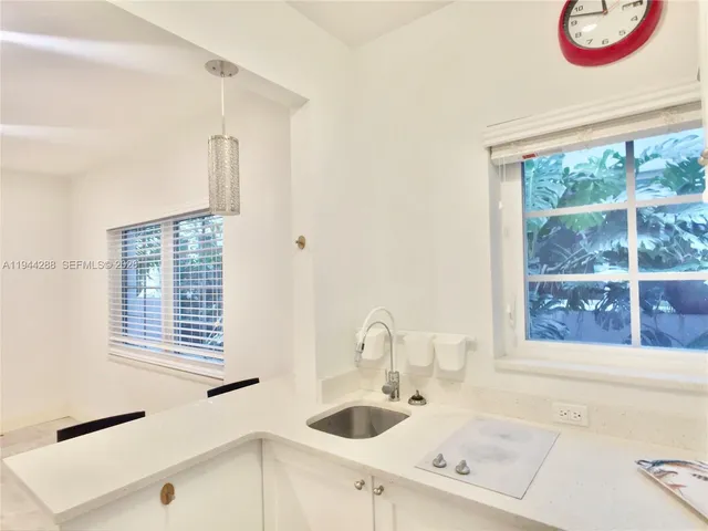 a bathroom with a sink and a large window