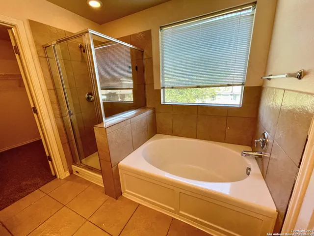 a bathroom with a tub and a shower