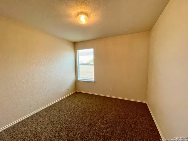 an empty room with a empty space and a window