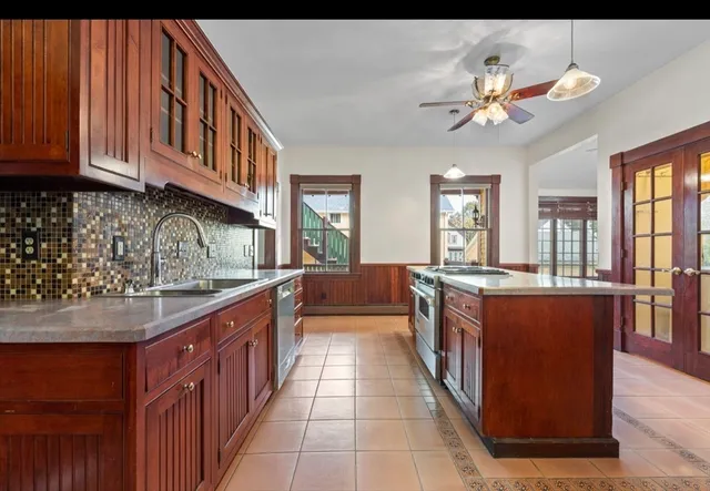a large kitchen with stainless steel appliances granite countertop a sink and dishwasher