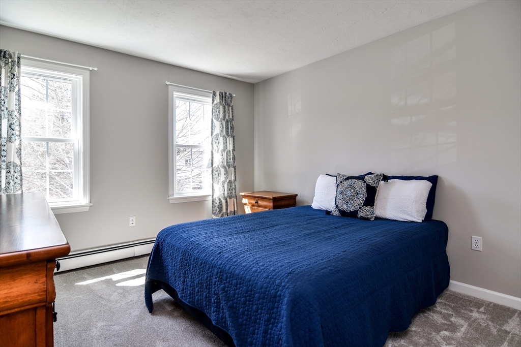 16 Russet Hill Road Ashland, MA 01721 - Photo 15 of 30 a large bed sitting in a bedroom next to a window