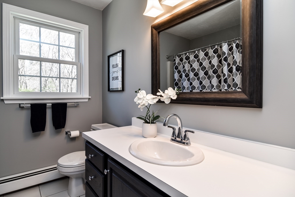 16 Russet Hill Road Ashland, MA 01721 - Photo 17 of 30 a bathroom with a sink a toilet and mirror