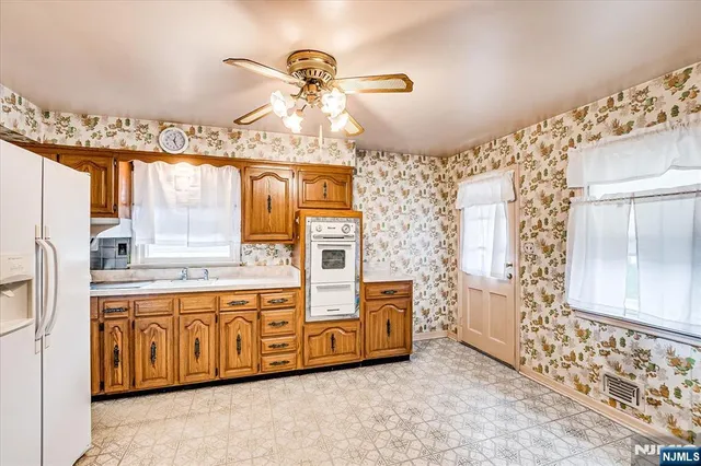 a kitchen with cabinets a island and stainless steel appliances