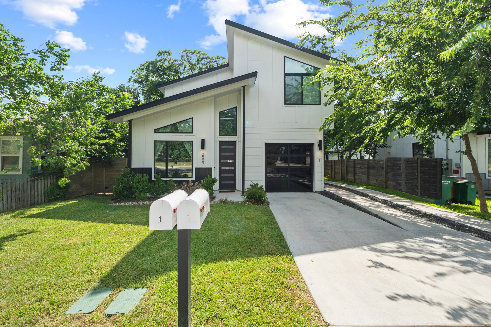 2007 Chestnut Avenue, Unit 1 Austin, TX 78722 - Photo 1 of 32 Bold contemporary lines define this striking white home, boasting an attached garage and a private driveway.
