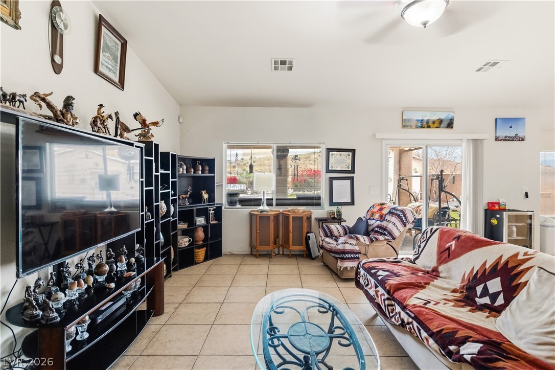 2516 Morrow Ridge Place Laughlin, NV 89029 - Photo 12 of 93 Living area featuring light tile patterned floors, healthy amount of natural light, and ceiling fan