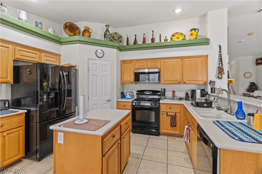 2516 Morrow Ridge Place Laughlin, NV 89029 - Photo 18 of 93 Kitchen with black appliances, light tile patterned floors, light countertops, a kitchen island, and recessed lighting