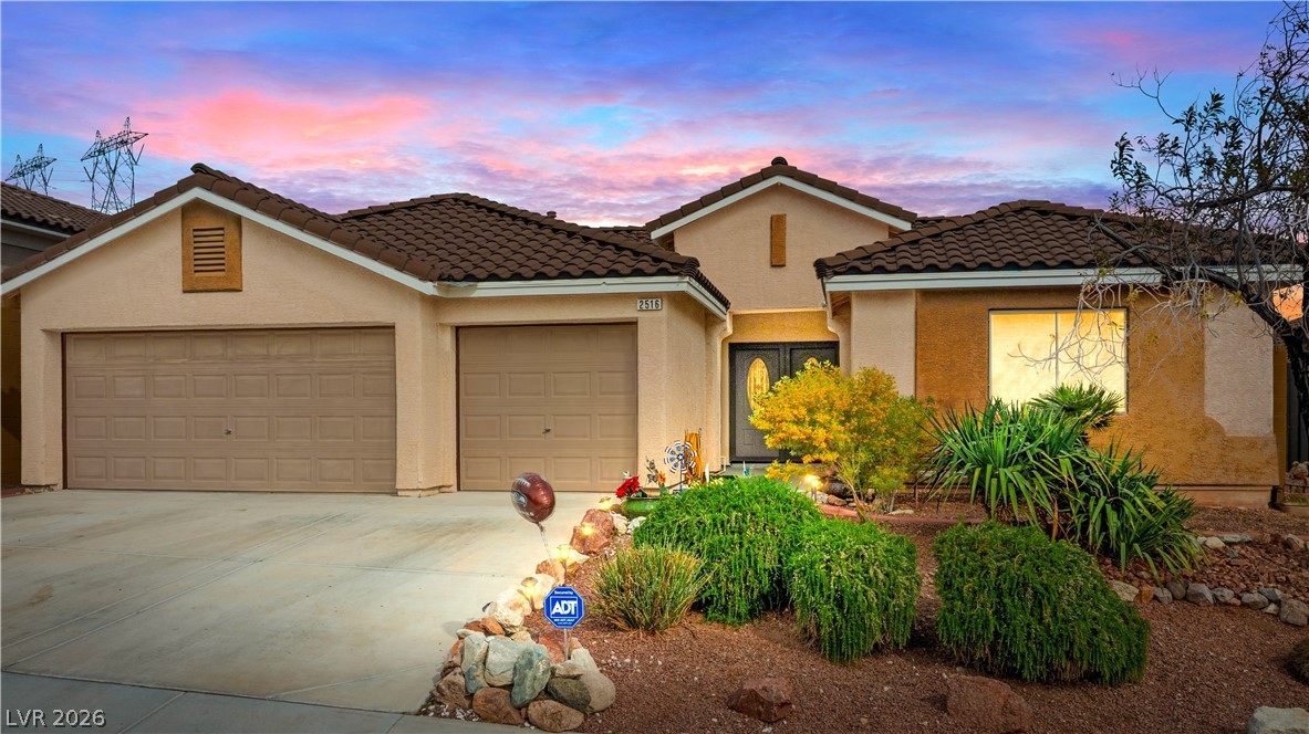 2516 Morrow Ridge Place Laughlin, NV 89029 - Photo 2 of 93 Mediterranean / spanish-style house with a garage, concrete driveway, stucco siding, and a tile roof