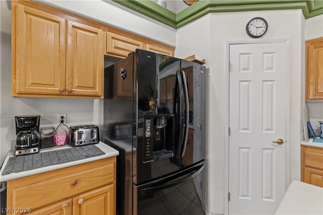 2516 Morrow Ridge Place Laughlin, NV 89029 - Photo 22 of 93 Kitchen with black refrigerator with ice dispenser, light countertops, and light wood finish cabinetry