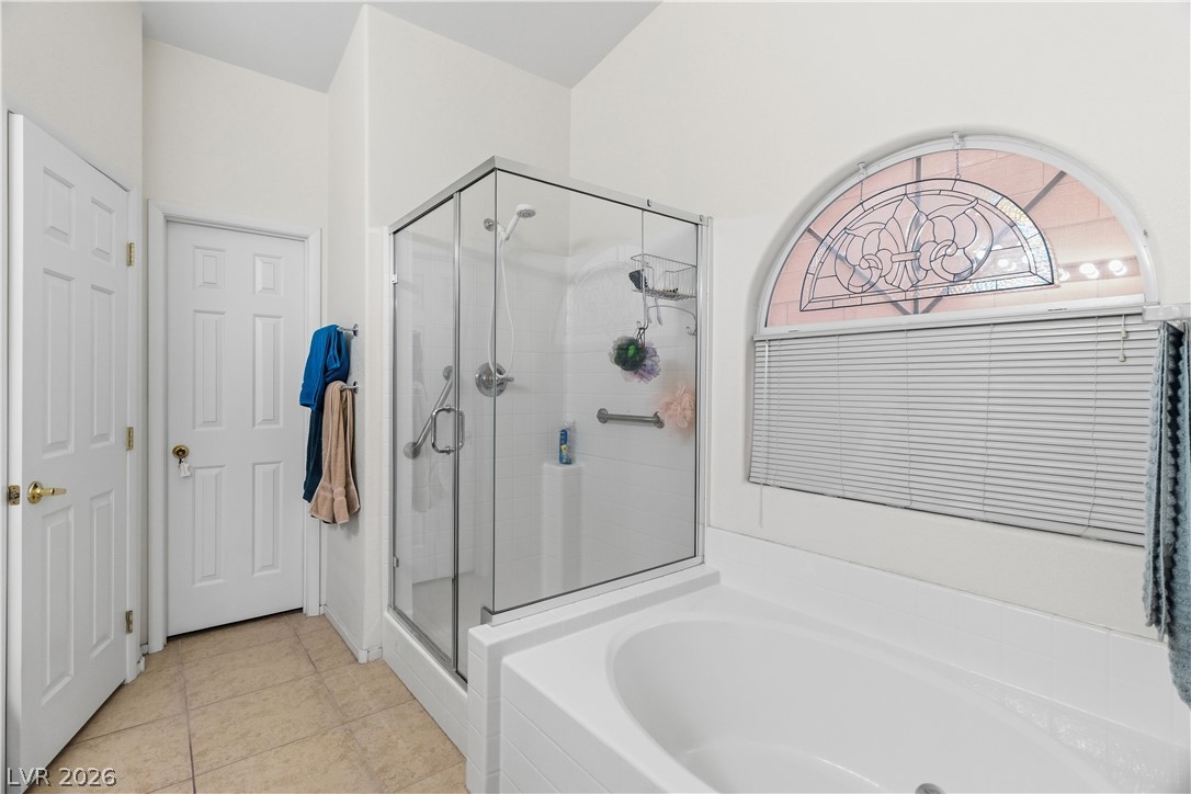 2516 Morrow Ridge Place Laughlin, NV 89029 - Photo 28 of 93 Full Primary bath with a stall shower, a garden tub, and light tile patterned flooring