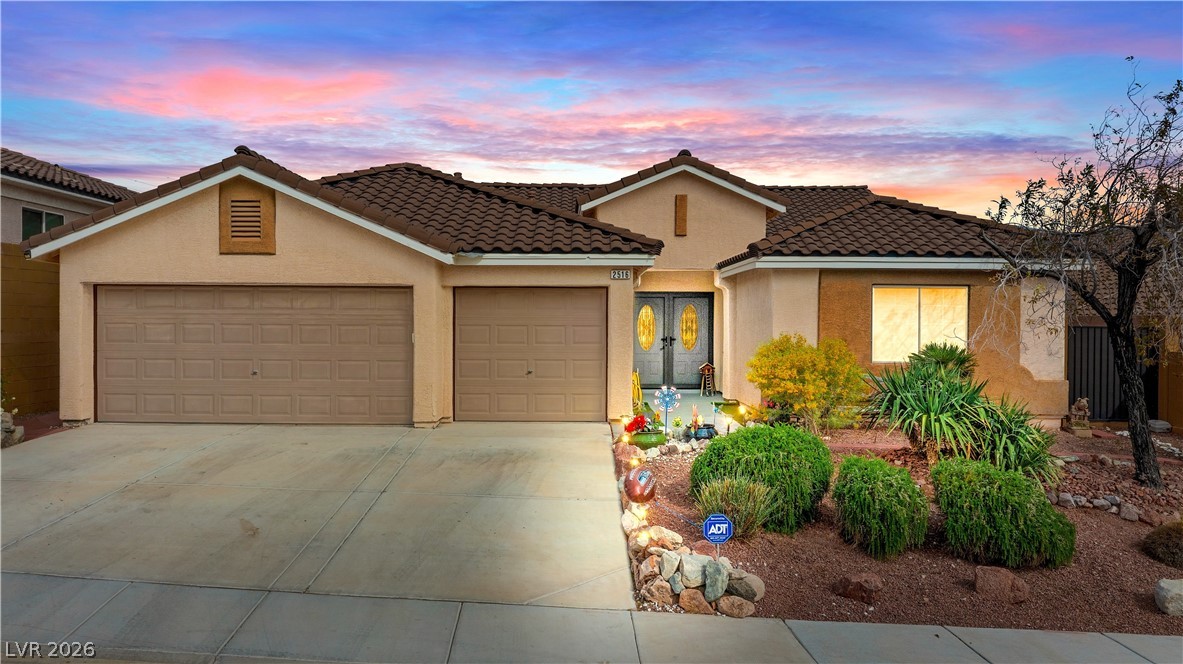 2516 Morrow Ridge Place Laughlin, NV 89029 - Photo 3 of 93 View of front of home with stucco siding, concrete driveway, an attached garage, french doors, and a tile roof